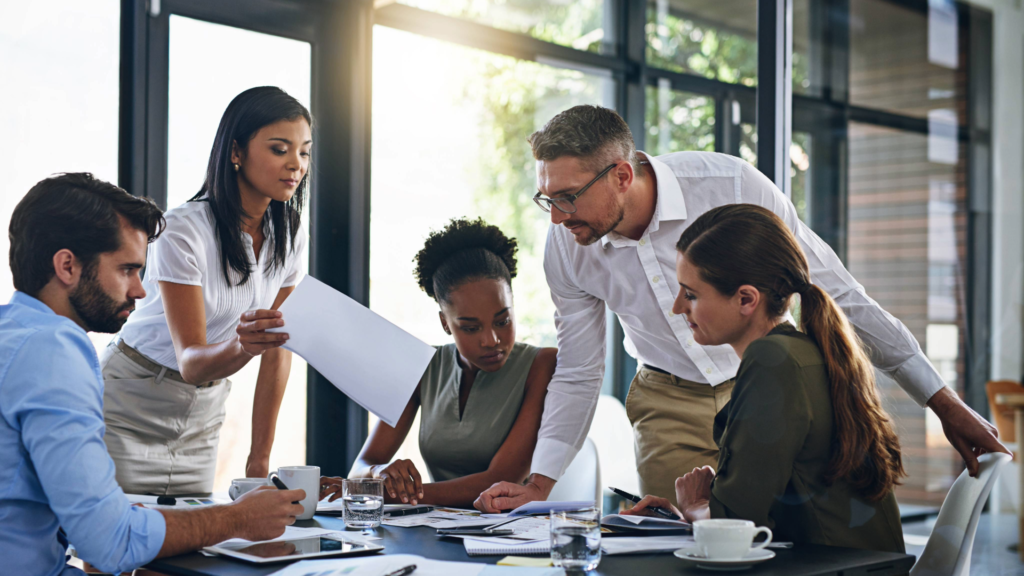Five team members collaborate on their customers’ priorities and needs.