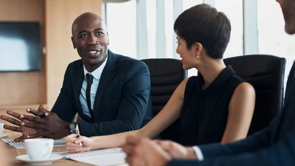 Business owner and fractional VP of sales in discussion, planning strategic hiring to boost sales.
